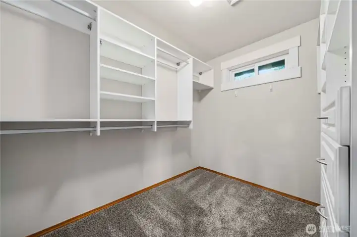 Primary walk-in closet with custom shelving