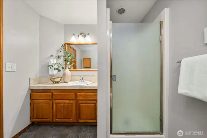 The primary bathroom features a shower and seperate bath tub