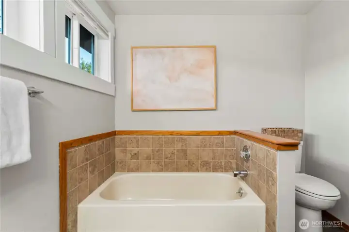 The hall bath features a shower and seperate bath tub