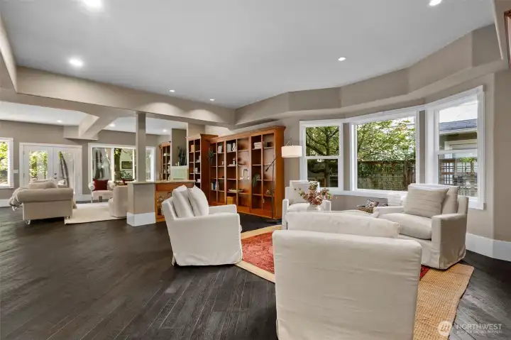 Soaring ceilings and expansive windows flood the home with natural light, creating a warm, inviting ambiance that’s perfect for both intimate gatherings and grand entertaining.