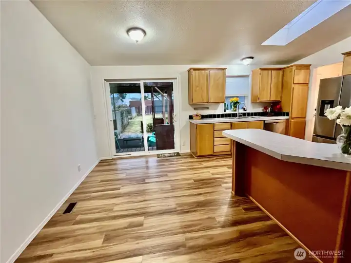 Dining room leading to kitchen and patio door to deck