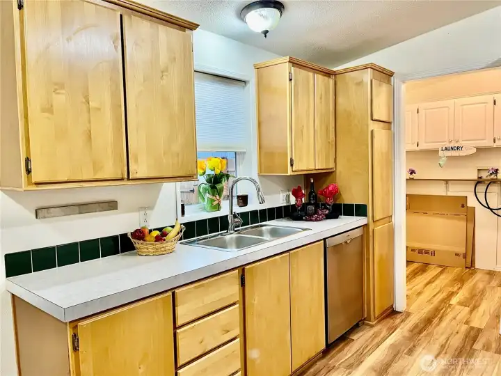 Lots of cabinets in kitchen and window to look at the backyard