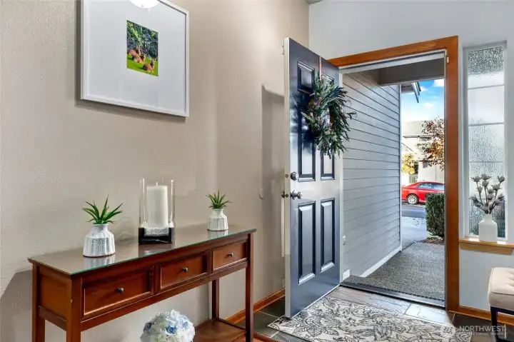 Inviting front entry with tile floor leads to solid hardwood flooring on main level as well as upstairs.
