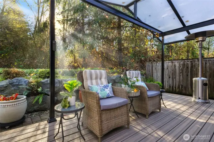 Enjoy year-round outdoor living on the spacious back deck featuring low-maintenance composite decking and a translucent covered roof that filters natural light while keeping the elements out. The deck overlooks 16 acres of Greenbelt, offering peaceful privacy, greenery, and wildlife views with no neighbors behind you.