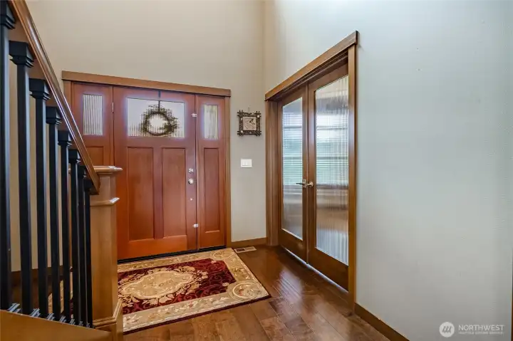 Entry with glass french doors opening into office.