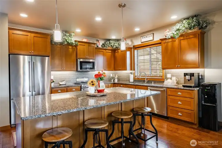 Quartz counters & all stainless appliances. Beautiful wood cabinets throughout home.