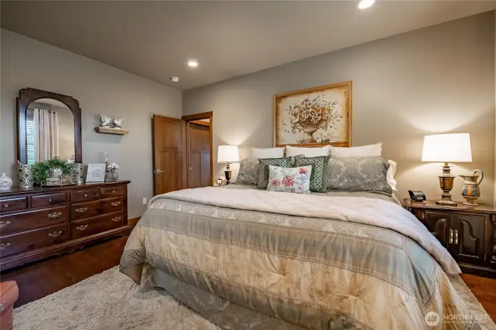 Primary bedroom on main level with attached bathroom and walk-in closet.