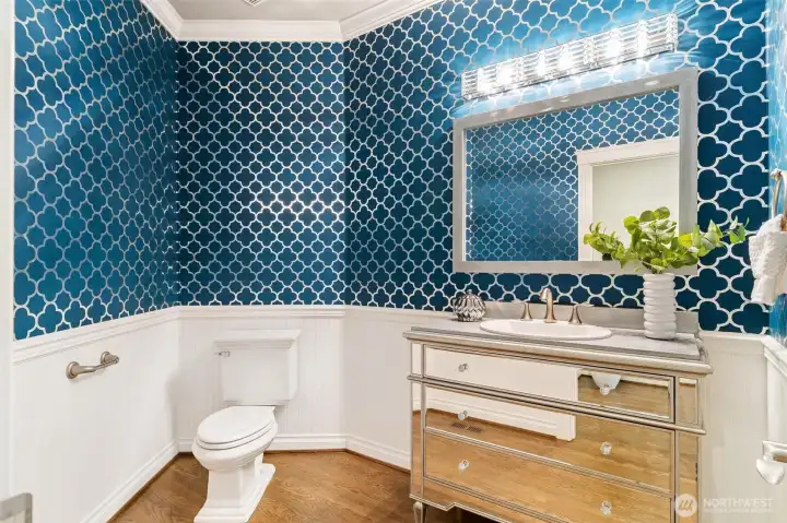 Spacious 1/2 bathroom with custom built in sink.