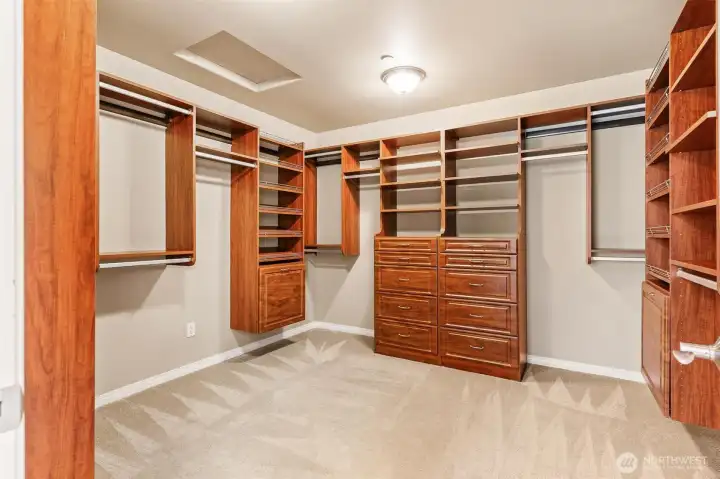 Expansive custom closet system with extensive shelving and hanging space.