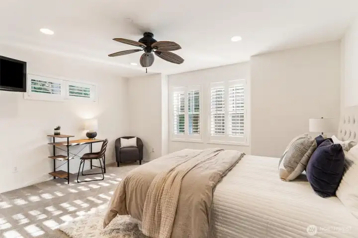 4th bedroom with built-in tv and closet with shelving, large windows
