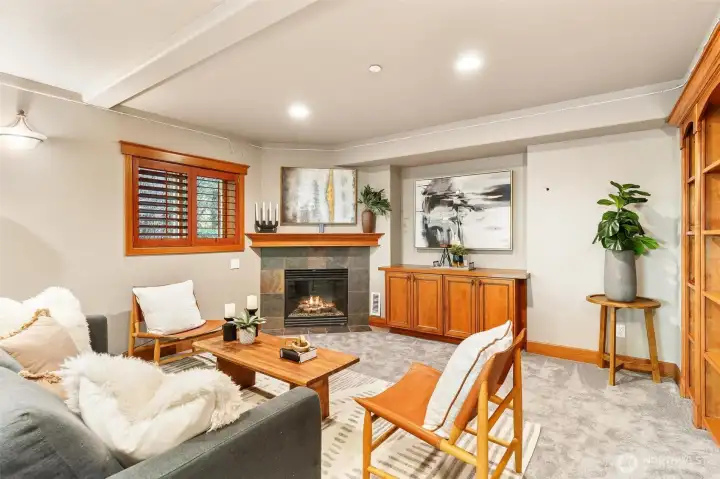 Basement rec room with gas fireplace and built-in TV stand hardwired for TV.