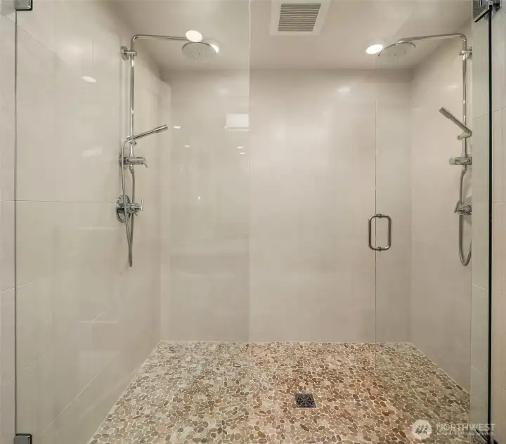 Expansive dual-headed shower with bespoke storage shelving