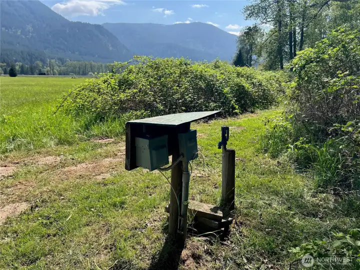RV hookups back beyond the garden area, next to beautiful river beach access.