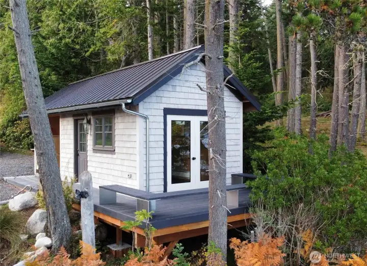 Perched just above the beach, the boathouse deck features French doors that open to the shoreline, creating an intimate, one-of-a-kind space to take in the sights and sounds of the water.