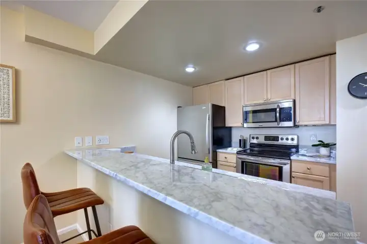 Kitchen with gorgeous granite slab countertops.