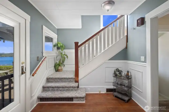 Stairway leading to primary bedroom, full bath and 2 additional bedrooms.