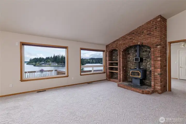 Lovely living room with lots of windows to enjoy the view. Free-standing wood stove to keep you toasty when it's cold outside. Lovely living room with lots of windows to enjoy the view. Free-standing wood stove to keep you toasty when it's cold outside.