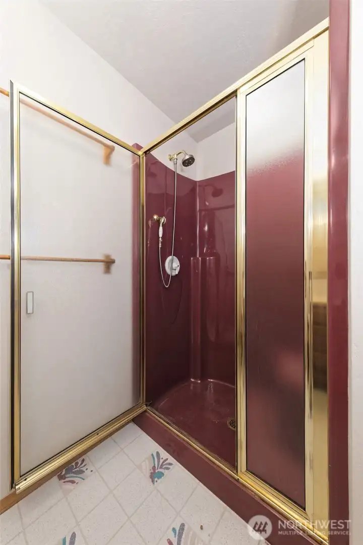 Primary bathroom with a step-in shower with a seat inside. Primary bathroom with a step-in shower with a seat inside.