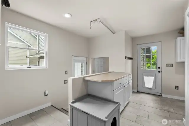 Laundry area with access to backyard.
