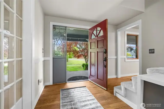 Welcoming entryway with natural light and warm wood floors.