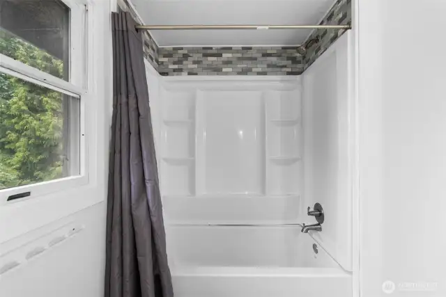 Bathroom with full size tub and shower.