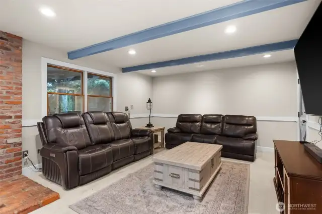 Spacious living room with modern lighting and cozy atmosphere.