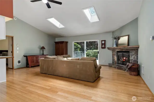 The foyer, opens into a large living area, with vaulted ceilings and skylights.