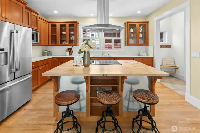The open-concept eat-in kitchen was recently updated with quartz countertops, new tile backsplash, sink and modern fixtures.