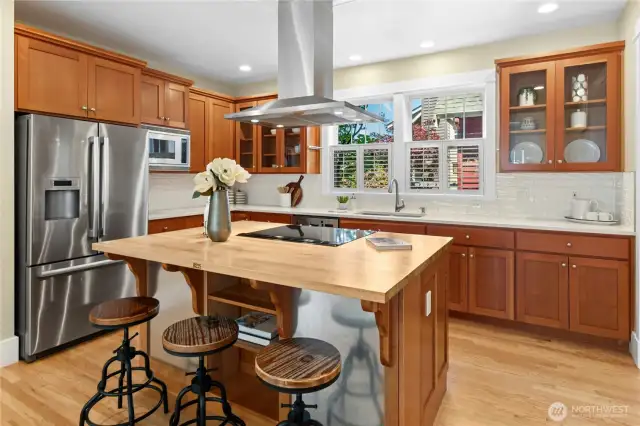 Eat-in kitchen with a large kitchen island topped with a Boos cutting board counter top.