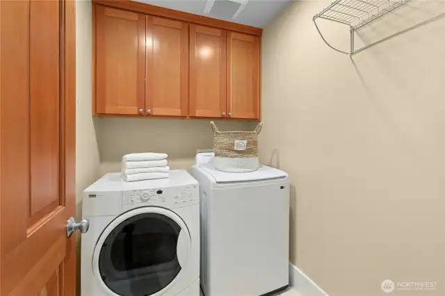 The upstairs laundry room with good cabinetry storage.