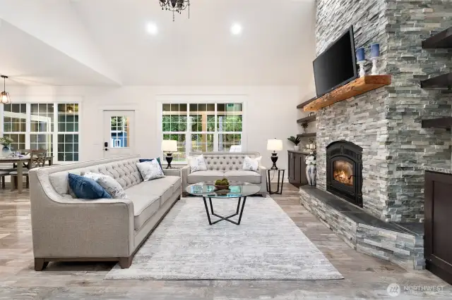 Soaring cathedral ceiling with wood fireplace insert and radiant heat flooring.