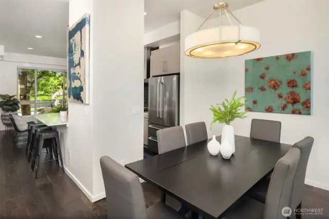 Dinning area with large windows showcasing the city and step onto the private balcony to enjoy amazing sunsets.