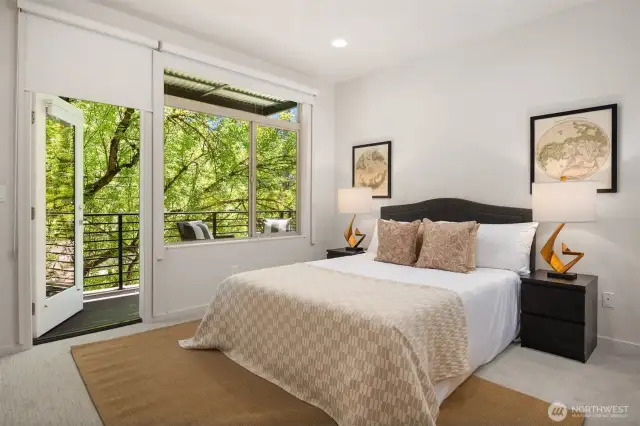 Primary suite and bathroom with private balcony and beautiful greenery.