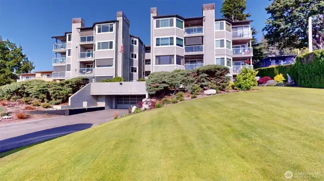 West side view & manicured grounds!