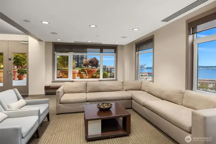 Amenity lounge opening to the large outdoor space with BBQ's on Floor 6.