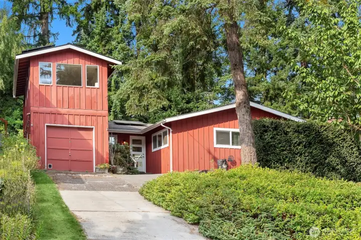 Perched up off the quiet street, this sweet rambler is one of a kind!