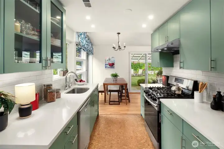 The gorgeous kitchen was updated in 2021 with new counters, cork floors, cabinets and stainless appliances.