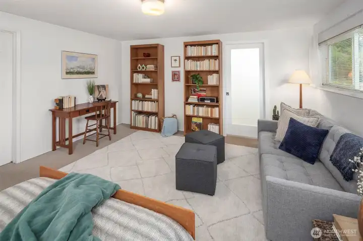 Another view of the primary suite, looking towards the walk-in closet and en suite bathroom