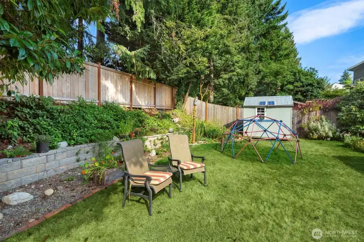 Newer retaining wall (2024), plus a calming water feature and the newer garden shed.
