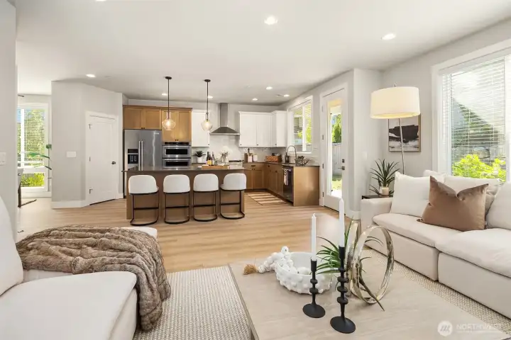 From living/great room into the kitchen.  White wood blinds throughout the home.