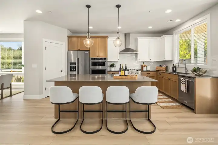 The heart of the home! Quartz island with seating for 4. Loads of storage for any chef. Walk-in pantry.