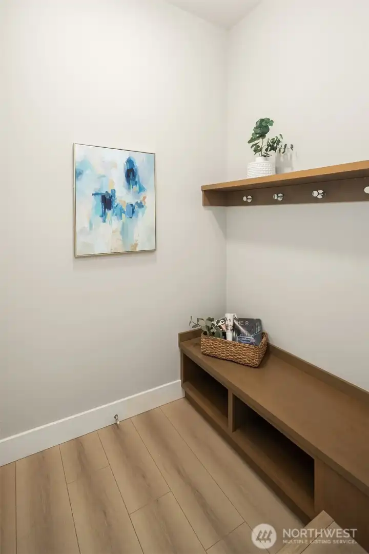 Greeting you from the garage, a mudroom for dropped school bags, coats and shoes.