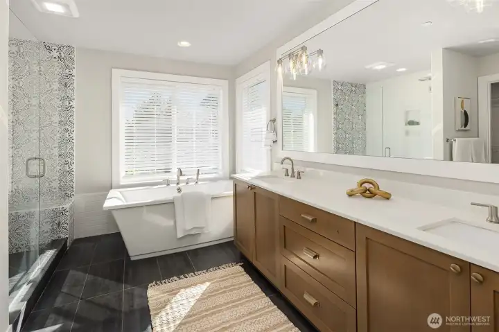 Relax and enjoy your spa bathroom with a luxurious soaking tub.  White quartz dual vanity and oversized shower.