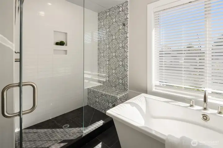 Oversized walk-in shower with built-in shelving.