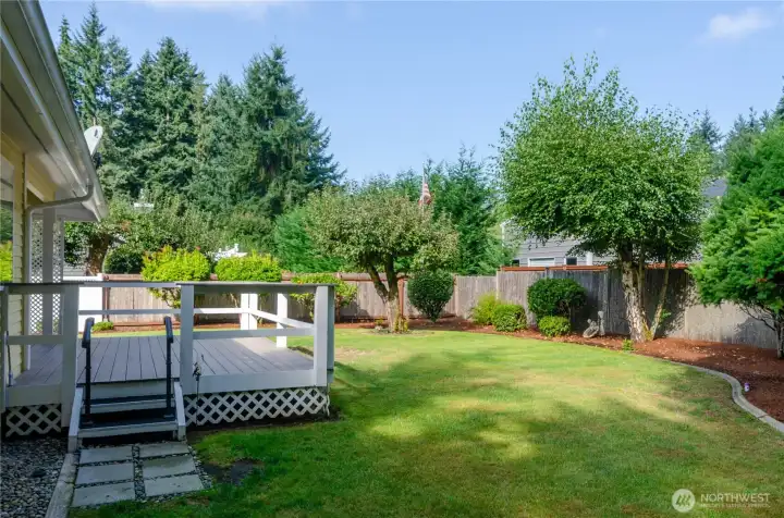 Beautiful landscaped and fenced backyard, trex deck is approximately 2 years old, partially covered.