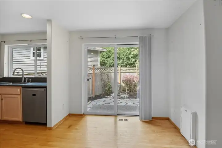 Cozy breakfast nook and a slider that opens up to the fenced back yard.