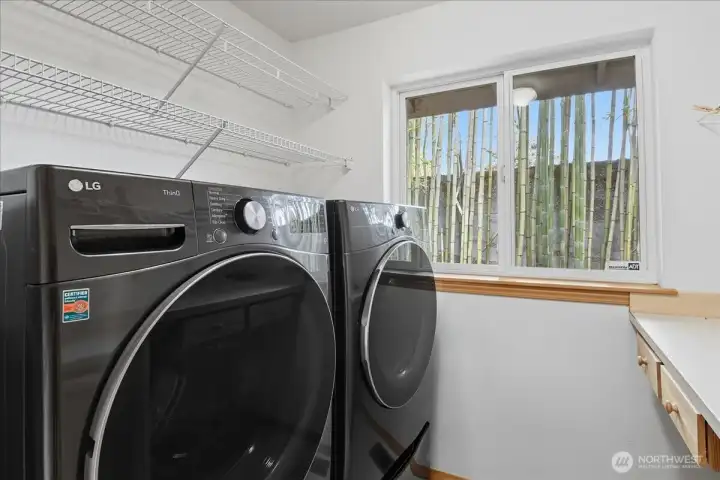 This is the laundry room that also has some storage and a folding shelf.