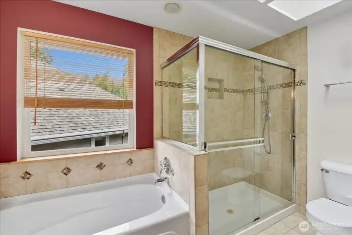 There is a luxurious soaking tub and spacious shower.