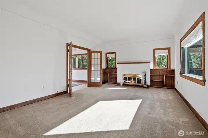 Spacious formal living room with fireplace and cove ceiling