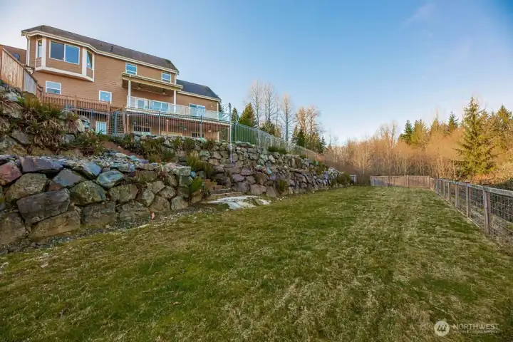 Huge flat run area with gate access for a riding mower. Could be an excellent dog run.